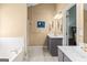 Bathroom featuring double sinks with silver fixtures, tile floor, and a soaking tub with a shower at 2515 Harbins Mill Dr, Dacula, GA 30019