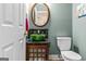 Powder room with a unique glass bowl sink on dark marble countertop and wooden cabinet at 2515 Harbins Mill Dr, Dacula, GA 30019