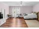 Bedroom featuring hardwood floors, a bed, a desk with a chair, and a piano at 2515 Harbins Mill Dr, Dacula, GA 30019