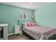 Cozy bedroom featuring light green walls and a double bed with nightstand and side lighting at 2515 Harbins Mill Dr, Dacula, GA 30019