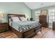 Spacious bedroom with a king-size bed, natural light, and hardwood floors at 2515 Harbins Mill Dr, Dacula, GA 30019