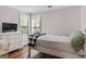 Bedroom with hardwood floors, white walls, and a flat-screen TV on the wall at 2515 Harbins Mill Dr, Dacula, GA 30019