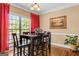 Inviting dining area with a large table, six chairs, red drapes, and a garden view at 2515 Harbins Mill Dr, Dacula, GA 30019