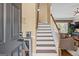 Welcoming entryway with hardwood stairs, a view into the living room, and decorative wall art at 2515 Harbins Mill Dr, Dacula, GA 30019