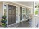Charming front porch featuring a brown door, welcome mat, and comfortable seating with a view at 2515 Harbins Mill Dr, Dacula, GA 30019