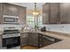 Well-lit kitchen features granite countertops, stainless steel appliances, and stained cabinets at 2515 Harbins Mill Dr, Dacula, GA 30019