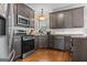 Elegant kitchen featuring stainless steel appliances, ample cabinet space, and hardwood floors for cooking at 2515 Harbins Mill Dr, Dacula, GA 30019