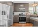 Contemporary kitchen with stainless steel appliances, dark wood cabinets, and granite countertops for a modern look at 2515 Harbins Mill Dr, Dacula, GA 30019