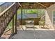 Cozy covered patio with swing seat, outdoor furniture, and string lights for relaxing evenings at 2515 Harbins Mill Dr, Dacula, GA 30019