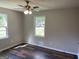 Well-lit room featuring wood floors and windows overlooking the outside, creating a serene and bright space at 300 Wood Rd., Hampton, GA 30228