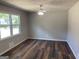 Spacious room with beautiful wood floors, neutral paint, ceiling fan, and a bright window at 300 Wood Rd., Hampton, GA 30228