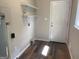 Bright laundry room featuring wood-look flooring and shelving, ready for personalization at 300 Wood Rd., Hampton, GA 30228