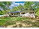 Beautiful single-story home with a black metal roof, white painted brick and charming front porch at 1200 Ridgeway Rd, Covington, GA 30014