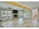 Bright living room featuring a brick fireplace, large windows, and hardwood floors at 1200 Ridgeway Rd, Covington, GA 30014