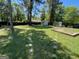A spacious backyard with lush green grass, garden, and a storage building at 1164 Interlaken Pass, Jonesboro, GA 30238