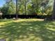 An expansive backyard with lush grass, mature trees, and ample space for recreation at 1164 Interlaken Pass, Jonesboro, GA 30238