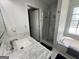 Bright bathroom with marble counters, glass enclosed shower and large soaking tub at 1164 Interlaken Pass, Jonesboro, GA 30238