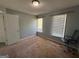 Bedroom features neutral walls, carpeted flooring, and two windows for ample natural light with a workstation at 1164 Interlaken Pass, Jonesboro, GA 30238