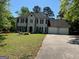 Traditional two-story home with attached two car garage and well maintained landscaping at 1164 Interlaken Pass, Jonesboro, GA 30238