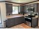 Modern kitchen with gray cabinets, stainless steel appliances, and granite countertops at 1164 Interlaken Pass, Jonesboro, GA 30238