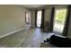 Open living room with tiled floors, large windows, and gray wall color at 1164 Interlaken Pass, Jonesboro, GA 30238