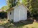 Exterior view of storage shed with a neutral color scheme and adjacent vegetation at 1164 Interlaken Pass, Jonesboro, GA 30238