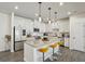 Bright kitchen features stainless steel appliances, granite countertops, and stylish pendant lighting at 375 Crider Ct, Woodstock, GA 30188