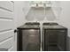 Convenient laundry room with modern washer and dryer units, with storage shelf at 375 Crider Ct, Woodstock, GA 30188