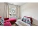 Bright living area with a red sofa, grey carpet, and an exterior view from the window at 375 Crider Ct, Woodstock, GA 30188
