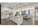 Open-concept living room showcases a modern kitchen with island and a cozy fireplace at 375 Crider Ct, Woodstock, GA 30188