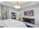 Bright and airy main bedroom with a modern TV, fireplace and contemporary design at 375 Crider Ct, Woodstock, GA 30188