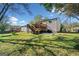 Expansive backyard featuring a wooden deck with stairs and a concrete patio, perfect for outdoor entertaining at 2406 Redfield Dr, Norcross, GA 30071