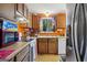 Functional kitchen with wooden cabinets, natural light, and necessary appliances for cooking at 2406 Redfield Dr, Norcross, GA 30071