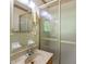 Bathroom featuring glass door shower, vanity with single sink and bright mirror at 242 Hickory Rd, Fayetteville, GA 30214