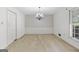 Carpeted dining room with chandelier and large windows at 242 Hickory Rd, Fayetteville, GA 30214