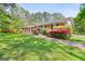Lovely single story brick home, well maintained lawn, mature landscaping at 242 Hickory Rd, Fayetteville, GA 30214