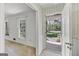 Inviting view from living room to the foyer with beautiful garden views through front door at 242 Hickory Rd, Fayetteville, GA 30214