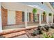 Inviting front porch with decorative hanging plants and a bench at 242 Hickory Rd, Fayetteville, GA 30214