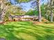 Well-maintained front yard with mature trees and a brick house at 242 Hickory Rd, Fayetteville, GA 30214