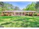 Classic brick home with a welcoming front porch and colorful landscaping at 242 Hickory Rd, Fayetteville, GA 30214