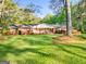 Charming brick house with a well-manicured front yard and blooming flowers at 242 Hickory Rd, Fayetteville, GA 30214
