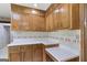 Traditional eat-in kitchen featuring wood cabinets, laminate counters and a center island at 242 Hickory Rd, Fayetteville, GA 30214