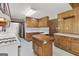 Traditional eat-in kitchen featuring wood cabinets, laminate counters and a center island at 242 Hickory Rd, Fayetteville, GA 30214