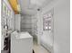 Functional laundry room with appliances, shelving, window, and an exterior access door at 242 Hickory Rd, Fayetteville, GA 30214