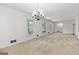Open living room with carpeted floors, neutral walls, view to dining room and large windows at 242 Hickory Rd, Fayetteville, GA 30214