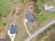 Aerial view of the home with a long drive, lawn, and wooded lot at 319 S Mount Carmel Rd, Mcdonough, GA 30253