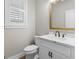 Powder bathroom features a white vanity with bronze fixtures and a gold framed mirror at 319 S Mount Carmel Rd, Mcdonough, GA 30253