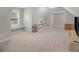 Upstairs bonus room with plush neutral carpet and built-in bookshelves for ample storage at 319 S Mount Carmel Rd, Mcdonough, GA 30253