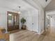 Inviting foyer boasts wood-look floors, shiplap accent walls, and a modern light fixture at 319 S Mount Carmel Rd, Mcdonough, GA 30253