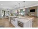 Bright, modern kitchen features a large island, stainless steel appliances, and pendant lighting at 319 S Mount Carmel Rd, Mcdonough, GA 30253